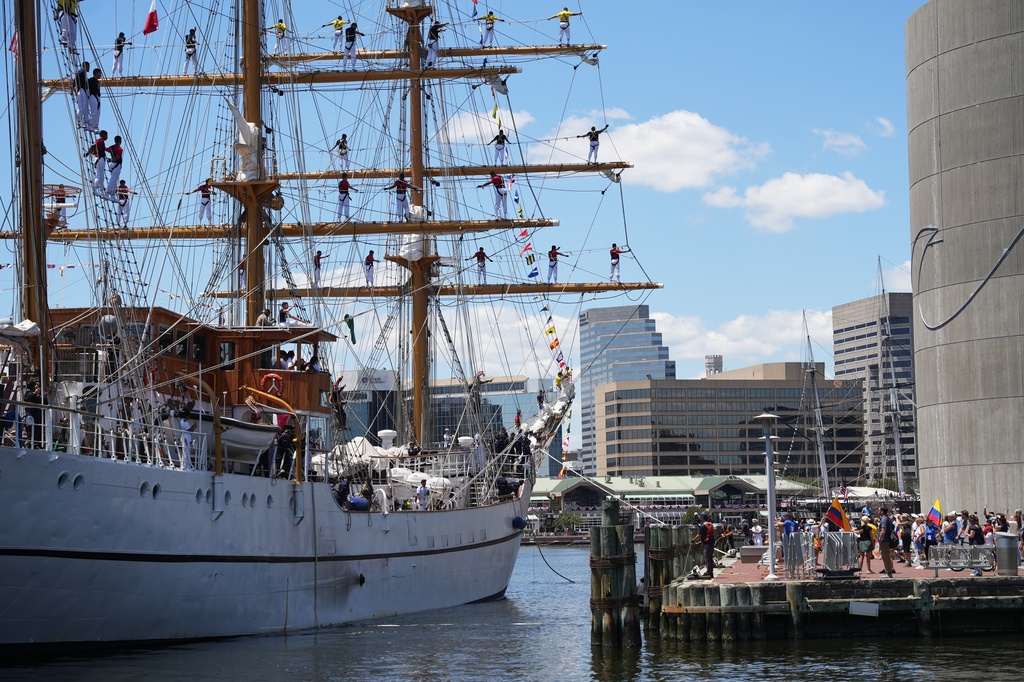 The crew of Ecuador's sail training vessel BAE Guayas wave to onlookers from the ship's mast as they dock at the Port of Baltimore ahead of the Sail250 event Wednesday, June 24, 2026, in Baltimore. (AP Photo/Mingson Lau)