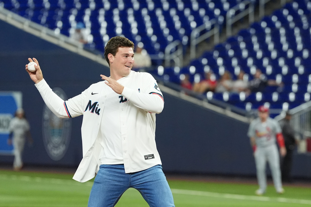 Indiana quarterback Fernando Mendoza throws out the ceremonial first pitch at the start of a baseball game between the Miami Marlins and the St. Louis Cardinals, Tuesday, April 21, 2026, in Miami. (AP Photo/Rebecca Blackwell)