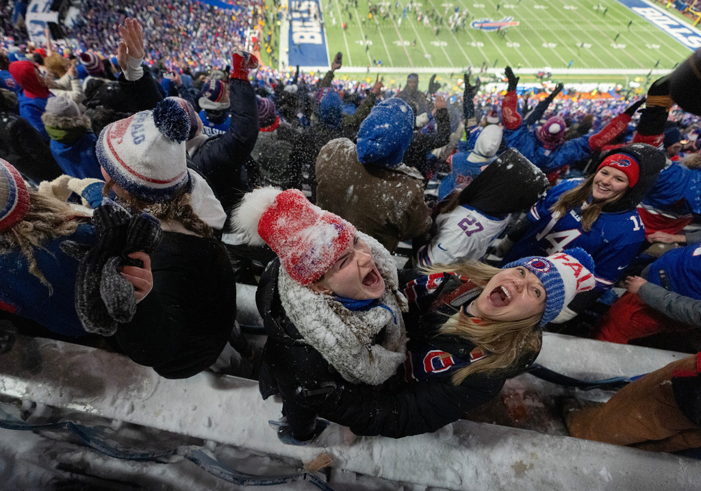 Fans celebrate and throw snow in the stands after an NFL football game between the Buffalo Bills and the New York Jets, Sunday, Jan. 4, 2026, in Orchard Park, N.Y. (AP Photo/Carolyn Kaster)