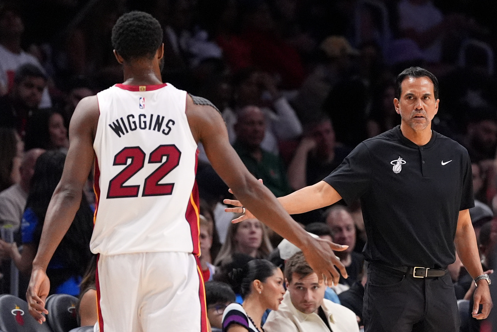 Miami Heat head coach Erik Spoelstra slaps hands with forward Andrew Wiggins (22) during the first half of an NBA basketball game against the Atlanta Hawks, Sunday, April 12, 2026, in Miami. (AP Photo/Rebecca Blackwell)
