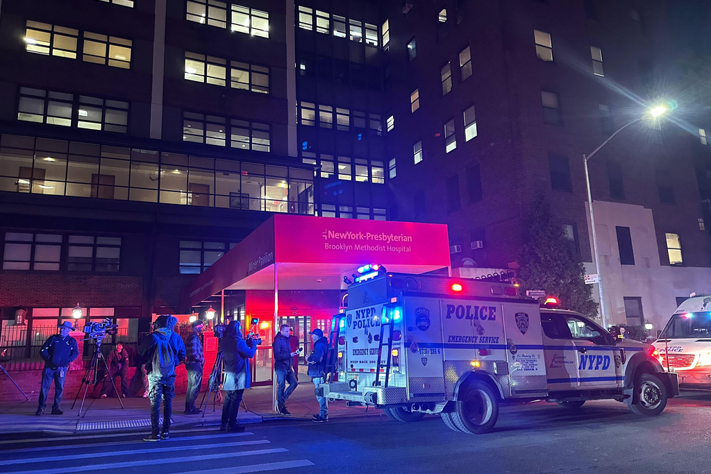Police vehicles are parked outside NewYork-Presbyterian Brooklyn Methodist Hospital Thursday, Jan. 8, 2026, in Brooklyn, N.Y., after an officer shot a man wielding a sharp object inside. (AP Photo/David Caruso)