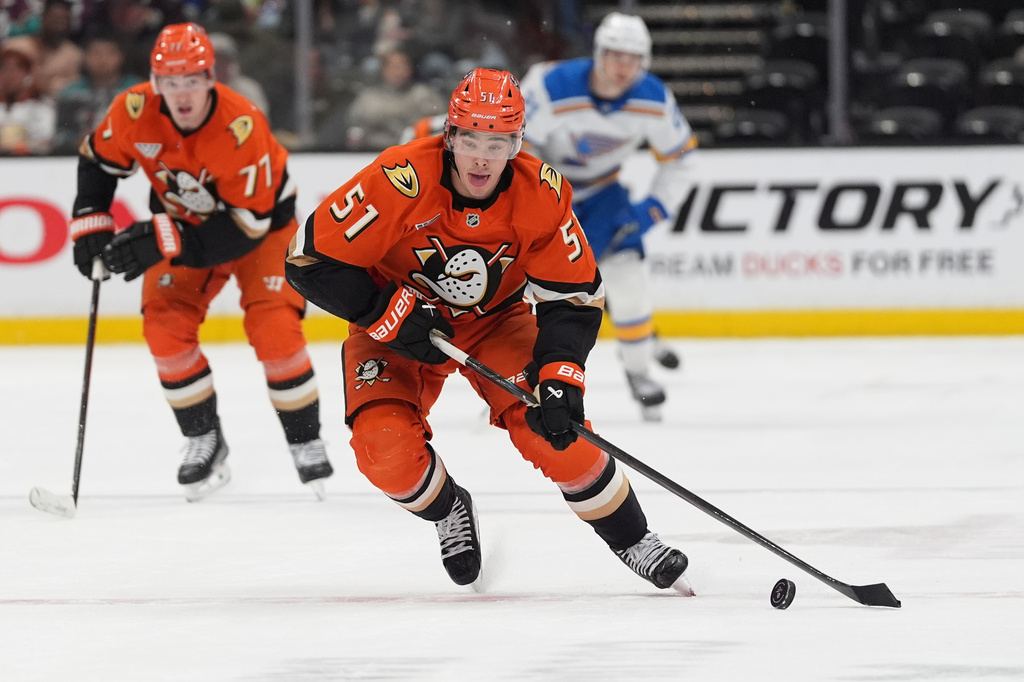 Anaheim Ducks defenseman Olen Zellweger (51) brings the up puck up the ice during the third period of an NHL hockey game against the St. Louis Blues Friday, April 3, 2026, in Anaheim, Calif. (AP Photo/Gregory Bull)