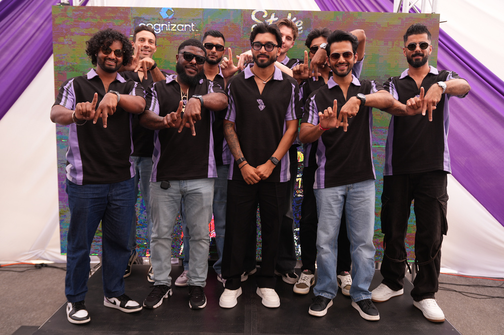 Members of the Los Angeles Knight Riders, cricket team form a LA sign with their hands as they pose for a picture at the Pomona Fairplex on Wednesday, April 22, 2026, during the groundbreaking ceremony of the new Knight Riders Cricket Field, which will serve as the Los Angeles Knight Riders' official home field for 2026 and later host cricket at the LA 2028 Olympics. (AP Photo/Damian Dovarganes)