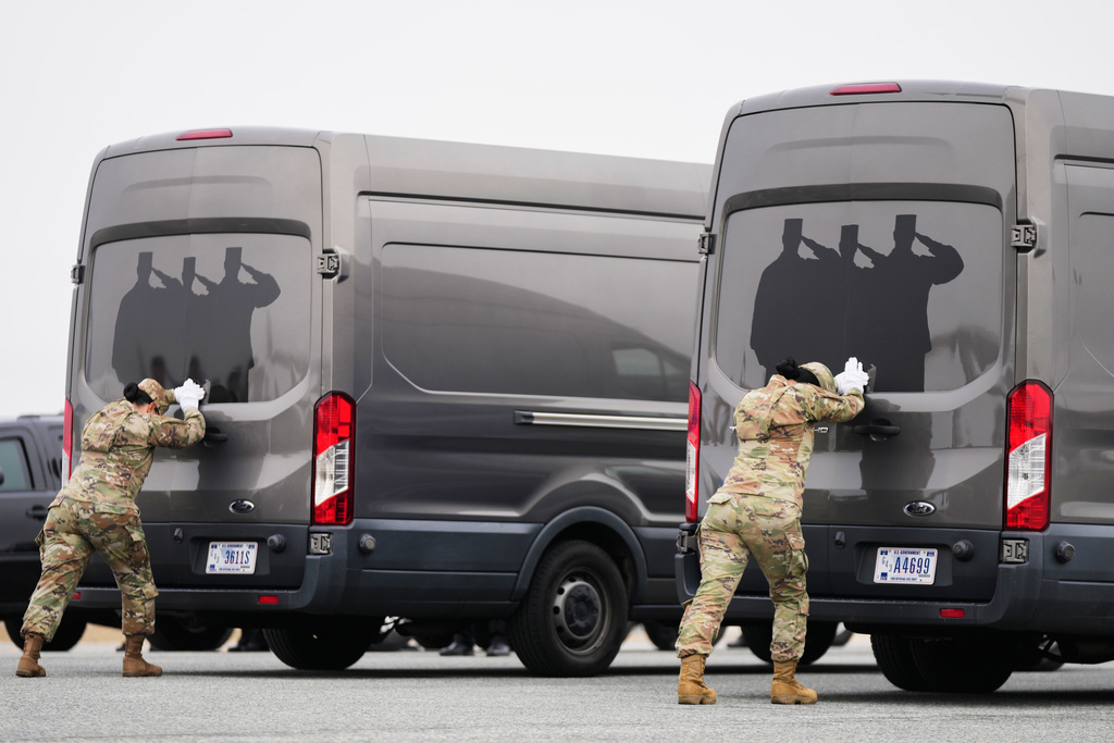 Door attendants U.S. Air Force Master Sgt. Christina Jiminez and Senior Airman Awng Dingrin secure the doors of the transfer vans containing the remains of U.S. Army Reserve soldiers Maj. Jeffrey O'Brien, 45, of Indianola, Iowa, Capt. Cody Khork, 35, of Winter Haven, Florida, Chief Warrant Officer 3 Robert Marzan, 54, of Sacramento, Sgt. 1st Class Nicole Amor, 39, of White Bear Lake, Minnesot, Sgt. 1st Class Noah Tietjens, 42, of Bellevue, Nebraska and Sgt. Declan Coady, 20, of West Des Moines, Iowa, who were killed in a drone strike at a command center in Kuwait after the U.S. and Israel launched its military campaign against Iran, during a casualty return, Saturday, March 7, 2026, at Dover Air Force Base, Del. (AP Photo/Mark Schiefelbein)