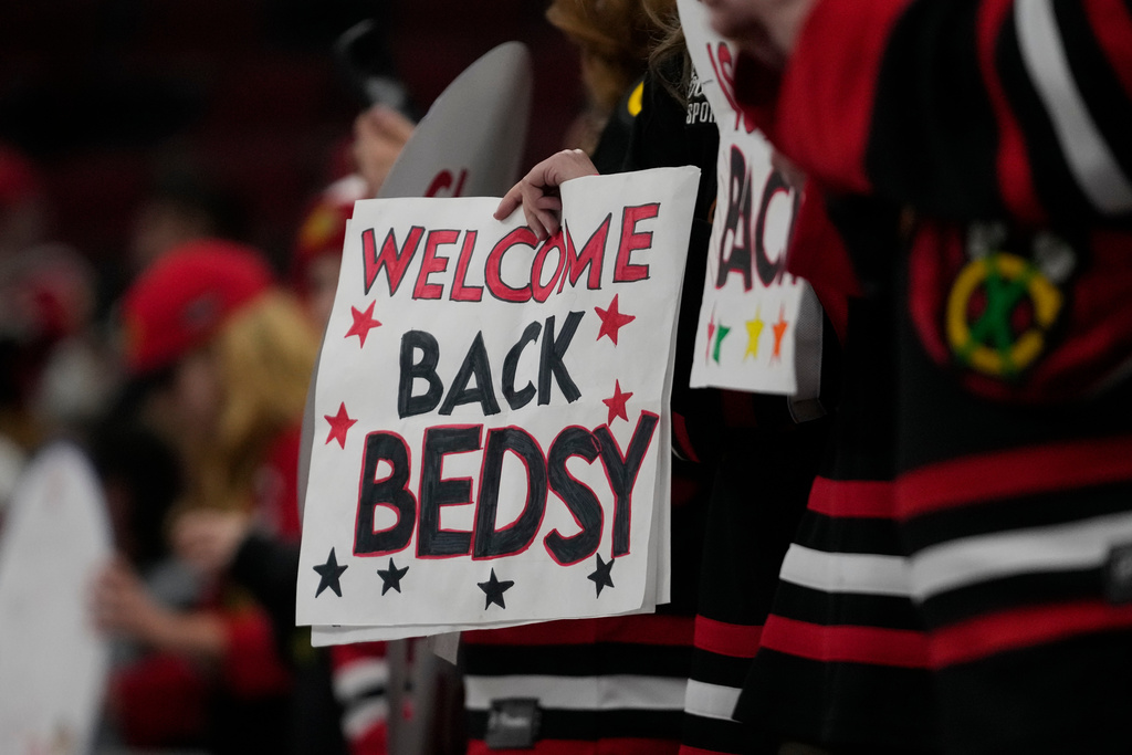 Hockey fans hold a sign as Chicago Blackhawks center Connor Bedard warms up before an NHL hockey game against the Washington Capitals, Friday, Jan. 9, 2026, in Chicago. (AP Photo/Erin Hooley)