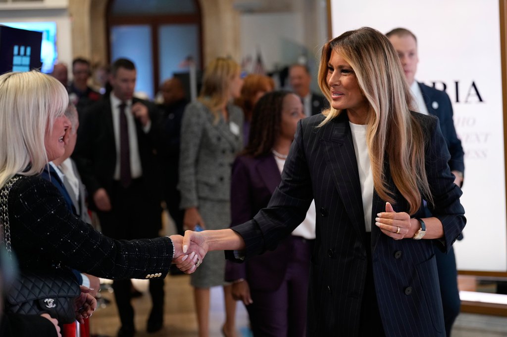 First lady Melania Trump, right, shakes hands as she prepares to ring the opening bell at the New York Stock Exchange Wednesday, Sept. 23, 2026, in New York. (AP Photo/Seth Wenig)