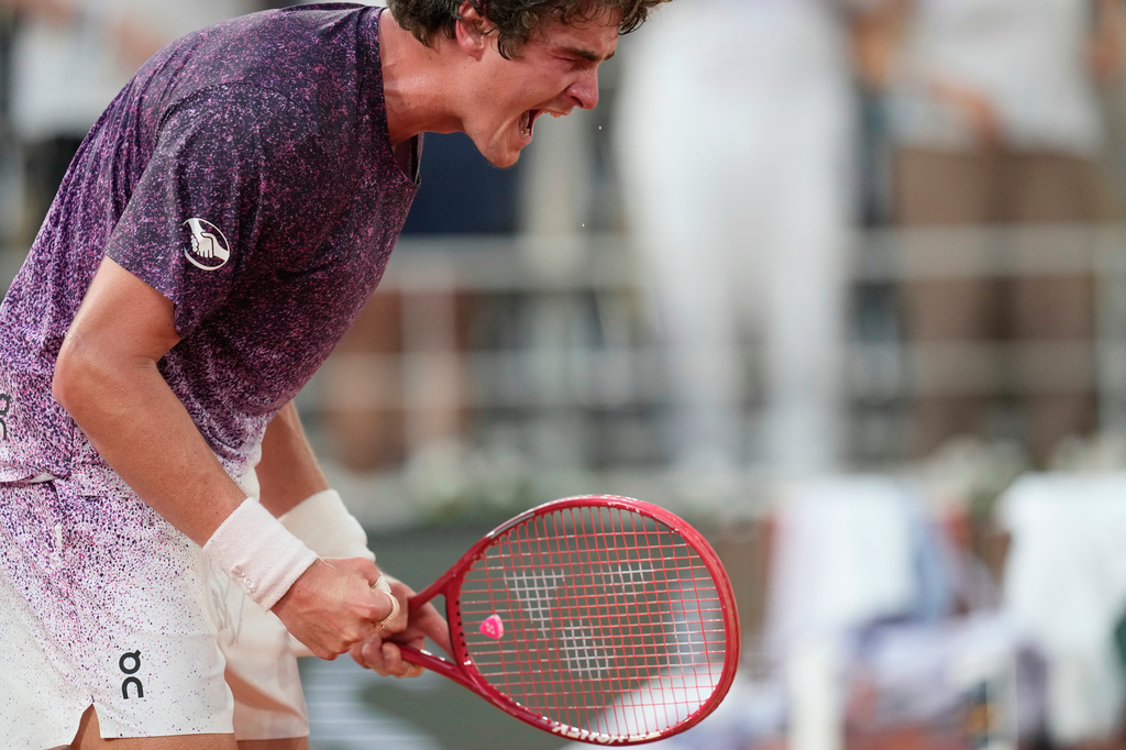 Joao Fonseca of Brazil celebrates winning the third round men's singles tennis match against Novak Djokovic of Serbia at the French Open tennis tournament in Paris, Friday, May 29, 2026. (AP Photo/Christophe Ena)