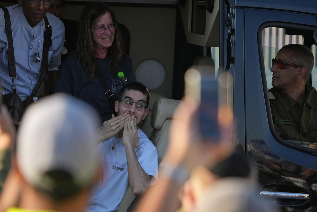 Freed Israeli hostage Evyatar David gestures from a van as he arrives at Beilinson hospital in Petah Tikva, Israel, after he was released from Hamas captivity in the Gaza Stripl, Monday, Oct. 13, 2025. (AP Photo/Ariel Schalit)