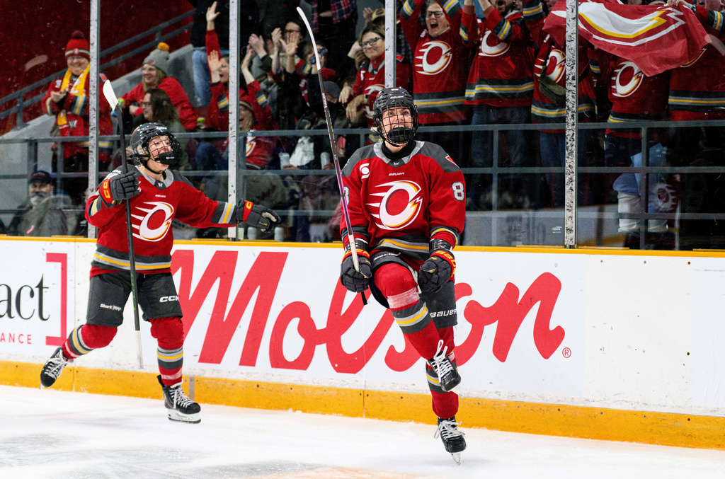 Ottawa Charge's Ronja Savolainen, right, celebrates after her goal against Vancouver Goldeneyes goaltender Kristen Campbell (not shown) during first-period PWHL hockey game action in Ottawa, Ontario, Friday, Jan. 9, 2026. (Spencer Colby/The Canadian Press via AP)