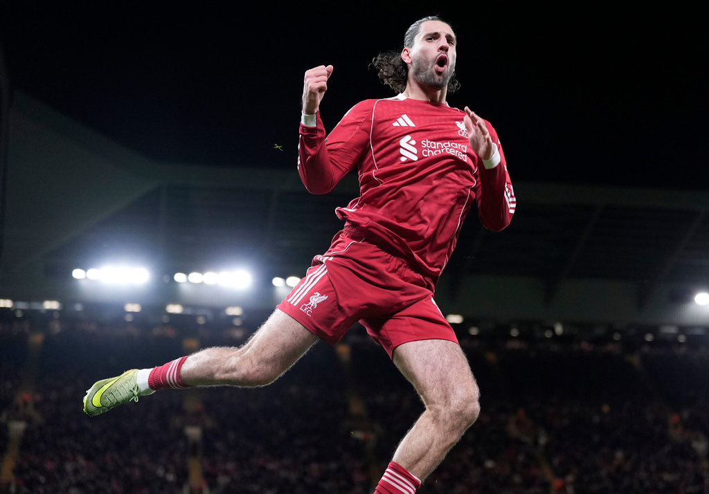 Liverpool's Dominik Szoboszlai jumps up as he celebrates after scoring his sides second goal during the English FA Cup fourth round soccer match between Liverpool and Brighton and Hove Albion in Liverpool, England, Saturday, Feb. 14, 2026. (Peter Byrne/PA via AP)