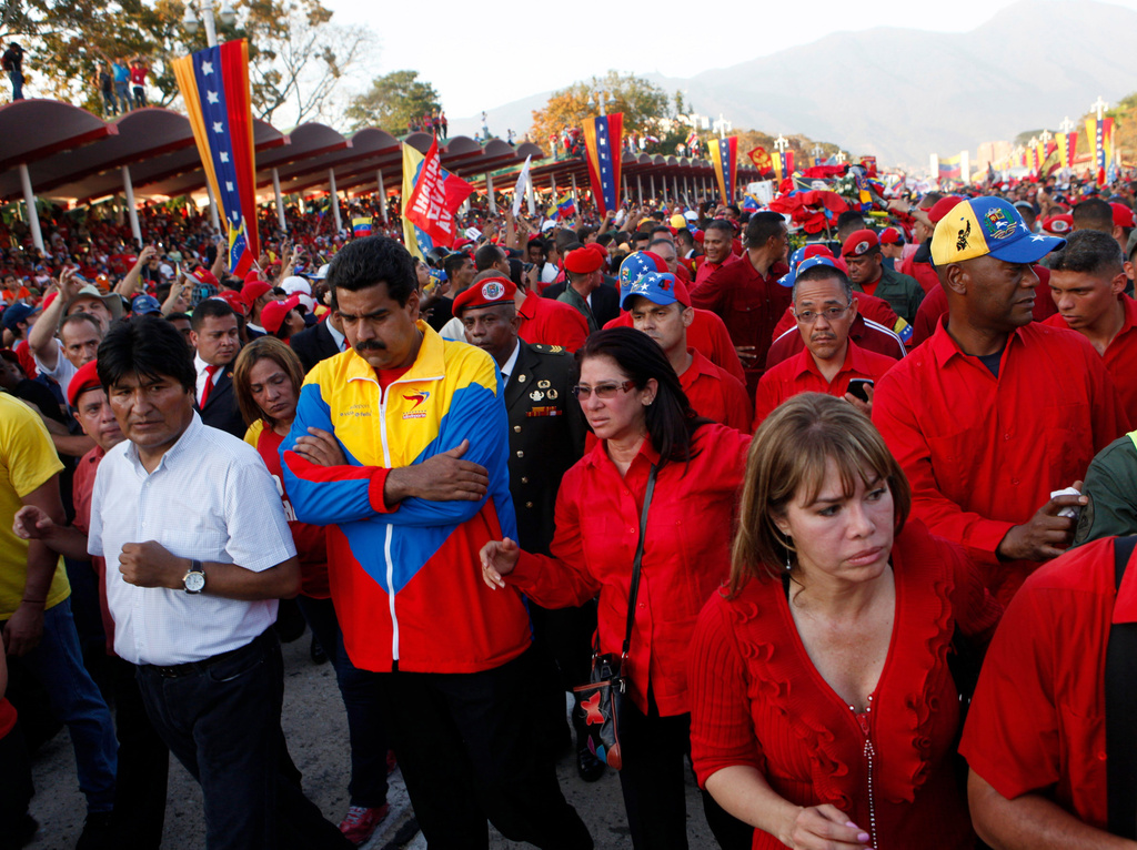 FILE - Bolivia's President Evo Morales, front left, Venezuela's Vice President Nicolas Maduro, second from left, and Attorney General Cilia Flores, third from left, walk in the procession carrying the coffin of Venezuela's late President Hugo Chavez from the hospital where he died, to the military academy where his body will lie in state in Caracas, Venezuela, March 6, 2013. (AP Photo/Esteban Felix, File)
