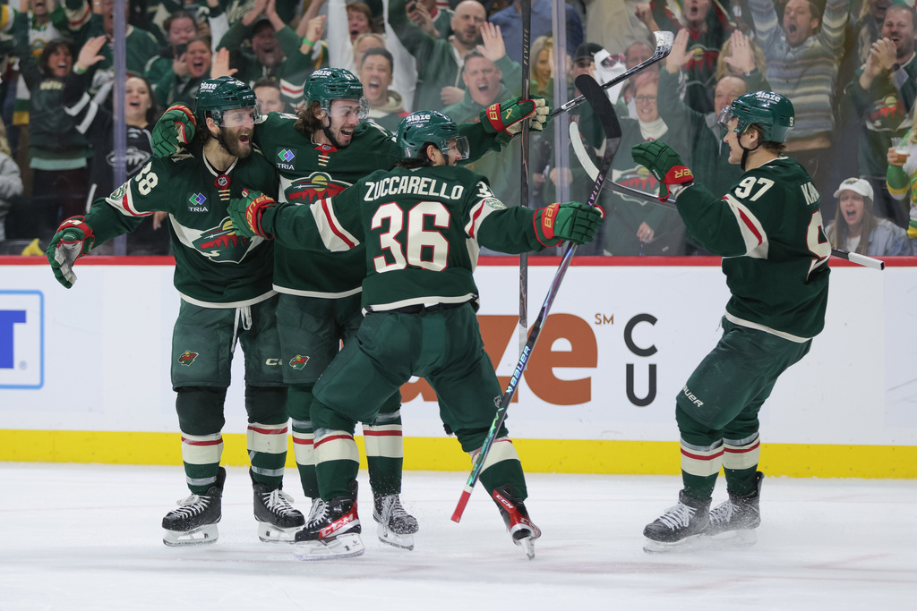 Minnesota Wild defenseman Quinn Hughes, second from the left, celebrates with teammates after scoring during the third period of Game 6 in the first round of the NHL hockey Stanley Cup playoff series against the Dallas Stars, Thursday, April 30, 2026, in St. Paul, Minn. (AP Photo/Bailey Hillesheim)