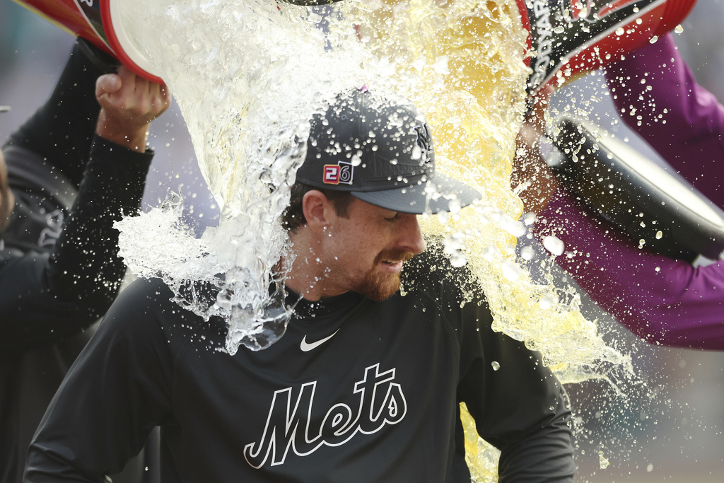 New York Mets pitcher Nolan McLean is doused by teammates after a win in a baseball game against the Seattle Mariners, Saturday, Aug. 16, 2025, in New York. (AP Photo/Heather Khalifa)