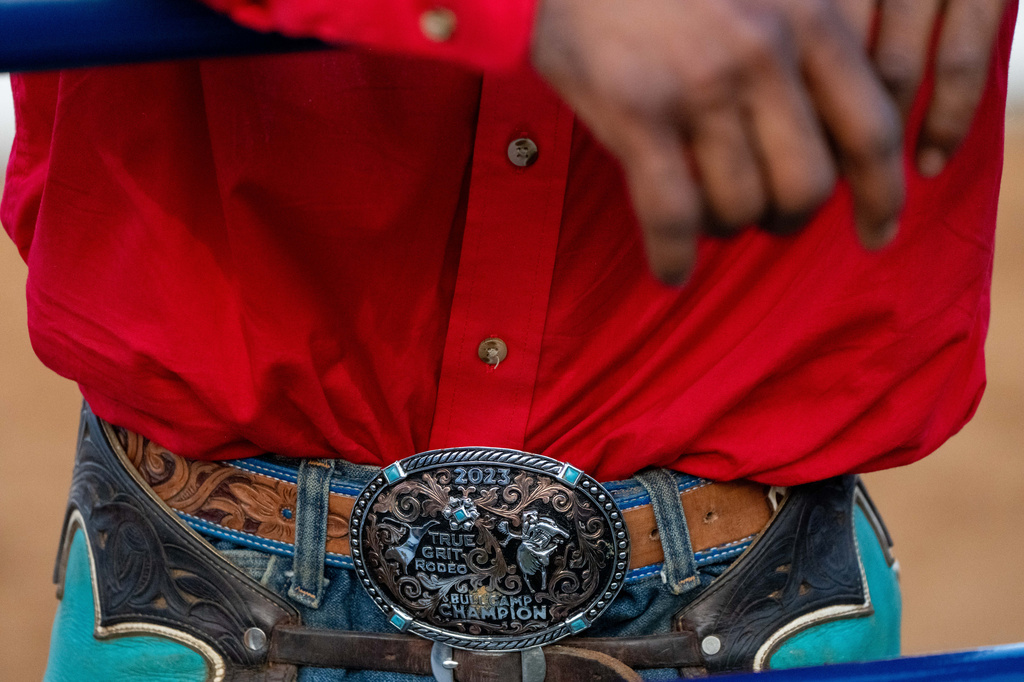 A cowboy leans on a rail at Rodeo 250 at the Great American State Fair on the National Mall, Tuesday, June 30, 2026, in Washington. (AP Photo/Alex Brandon)