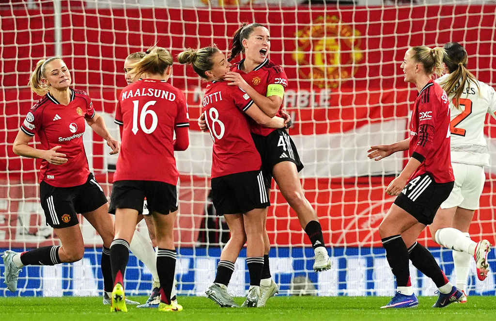 Manchester United's Maya Le Tissier, center, celebrates scoring their side's first goal of the game from the penalty spot during the Women's Champions League match between Manchester United and Bayern Munich in Manchester, England, Wednesday, March 25, 2026. (Martin Rickett/PA via AP)