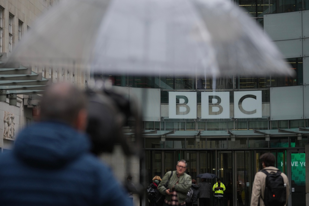 Media members wait outside the BBC Headquarters in London, Monday, Nov. 10, 2025. (AP Photo/Kin Cheung)