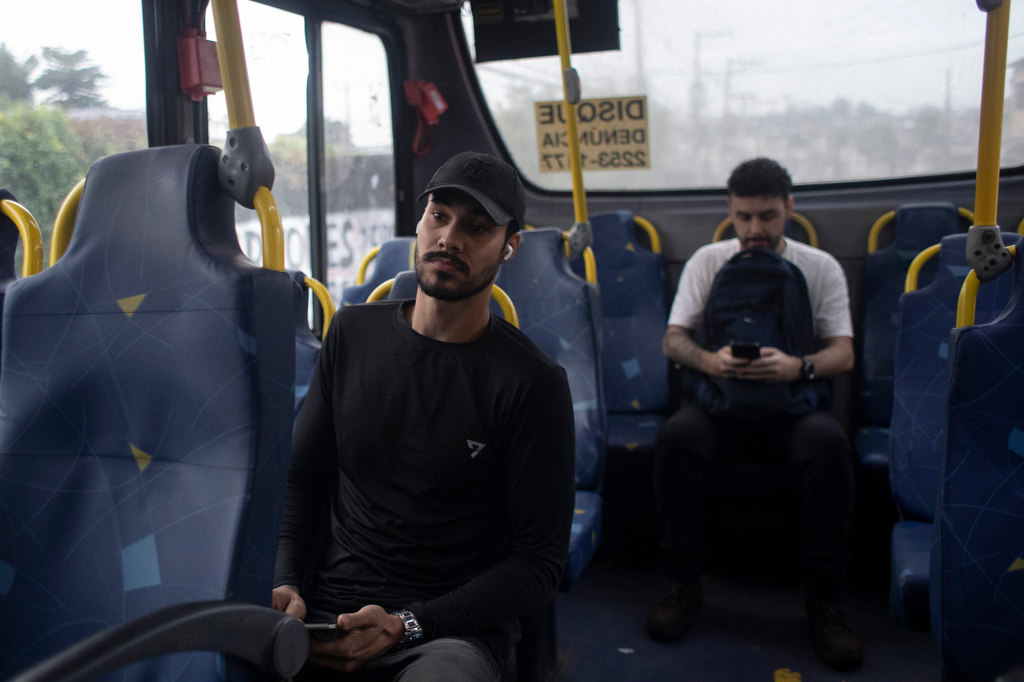 Matheus Paulo da Costa Silva listens to music while taking a bus to work in Rio de Janeiro, Friday, May 29, 2026. (AP Photo/Bruna Prado)