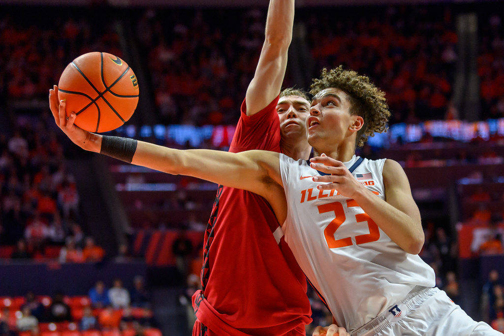 Illinois guard Keaton Wagler reaches towards the basket as Wisconsin's Andrew Rohde defends during the first half of an NCAA college basketball game, Tuesday, Feb. 10, 2026, in Champaign, Ill. (AP Photo/Craig Pessman)