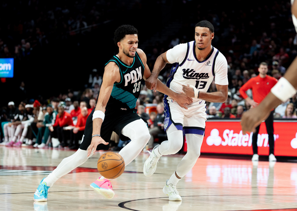 Portland Trail Blazers forward Toumani Camara, left, dribbles against Sacramento Kings forward Keegan Murray during the second half of an NBA basketball game, Thursday Dec. 18, 2025, in Portland, Ore. (AP Photo/Howard Lao)
