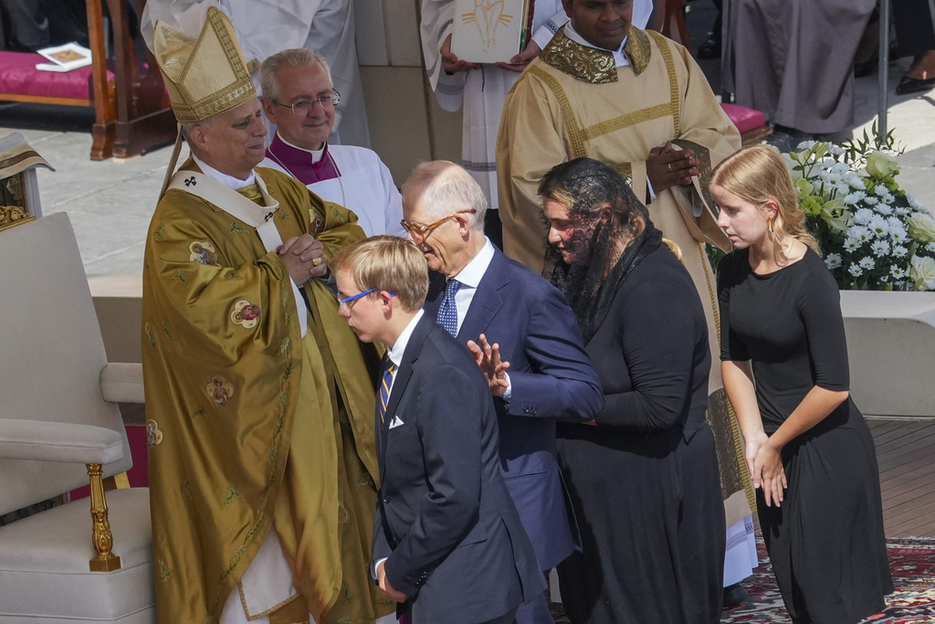 The family of Carlo Acutis, from right, sister Francesca, mother Antonia, father Andrea, and brother Michele, attend the canonization Mass celebrated by Pope Leo XIV, left, of Carlo Acutis and Pier Giorgio Frassati in St. Peter's Square at the Vatican on Sunday, Sept. 7, 2025. (AP Photo/Andrew Medichini)