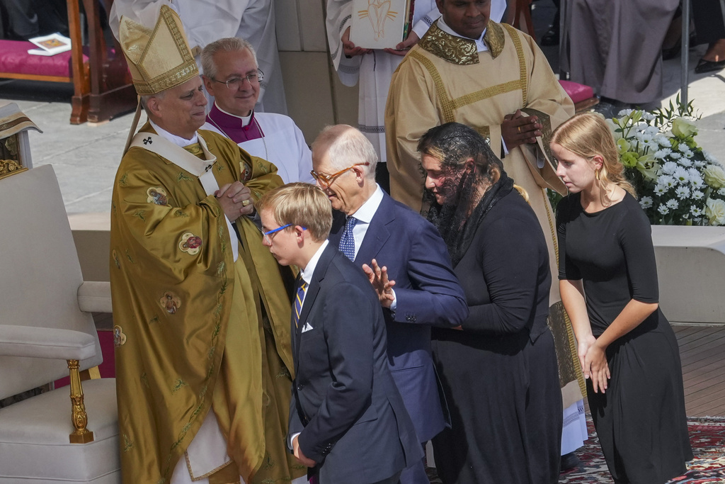 The family of Carlo Acutis, from right, sister Francesca, mother Antonia, father Andrea, and brother Michele, attend the canonization Mass celebrated by Pope Leo XIV, left, of Carlo Acutis and Pier Giorgio Frassati in St. Peter's Square at the Vatican on Sunday, Sept. 7, 2025. (AP Photo/Andrew Medichini)