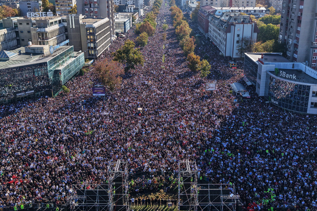 People fill the streets near the train station before observing 16 minutes of silence for the victims on the first anniversary of the disaster that killed 16 people, in Novi Sad, Serbia, Saturday, Nov. 1, 2025. (AP Photo/Armin Durgut)