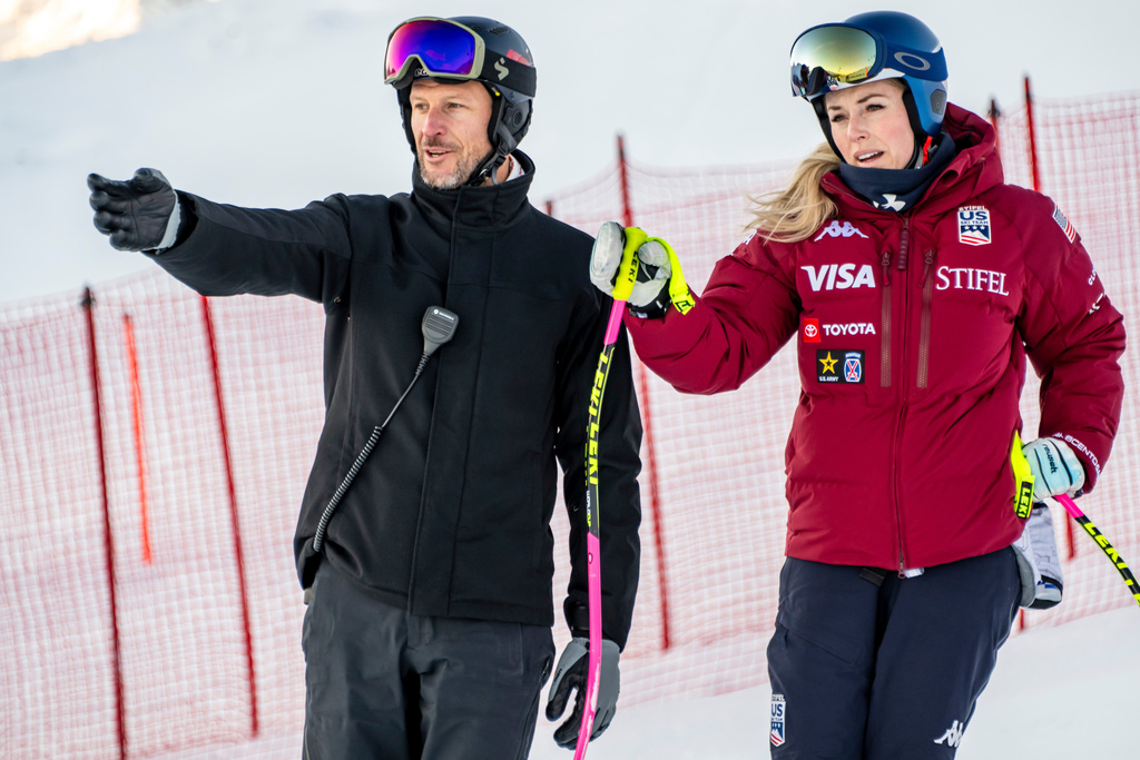 Lindsey Vonn, right, of the United States, and Coach and former Norwegian skier Aksel Lund Svindal, left, talk before the women's Downhill training race at the Alpine Skiing FIS Ski World Cup in St. Moritz, Switzerland, Wednesday, Dec. 10, 2025. (Jean-Christophe Bott/Keystone via AP)