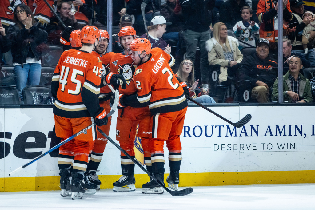 Anaheim Ducks players celebrate after scoring against the Chicago Blackhawks during the first period of an NHL hockey game Sunday, Dec. 7, 2025, in Anaheim, Calif. (AP Photo/Ethan Swope)