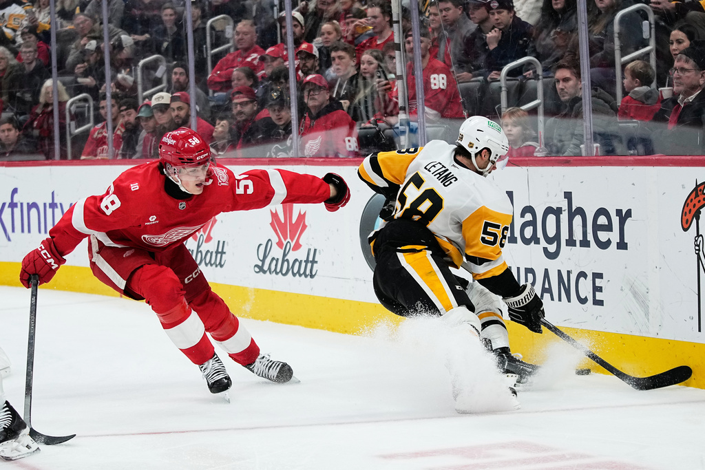 Detroit Red Wings center Emmitt Finnie, left, chases Pittsburgh Penguins defenseman Kris Letang during the second period of an NHL hockey game Saturday, Jan. 3, 2026, in Detroit. (AP Photo/Ryan Sun)