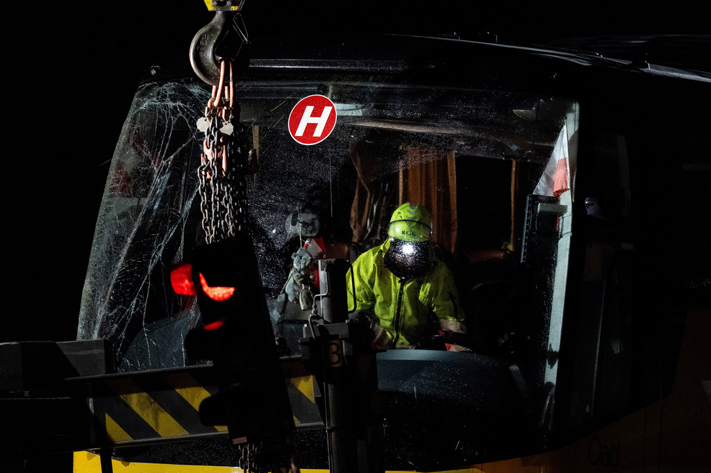 Emergency responders recover a travel coach after an accident in Susch in the canton of Grisons, Switzerland, on Friday, Sept. 11, 2026. (Claudio Thoma/Keystone via AP)