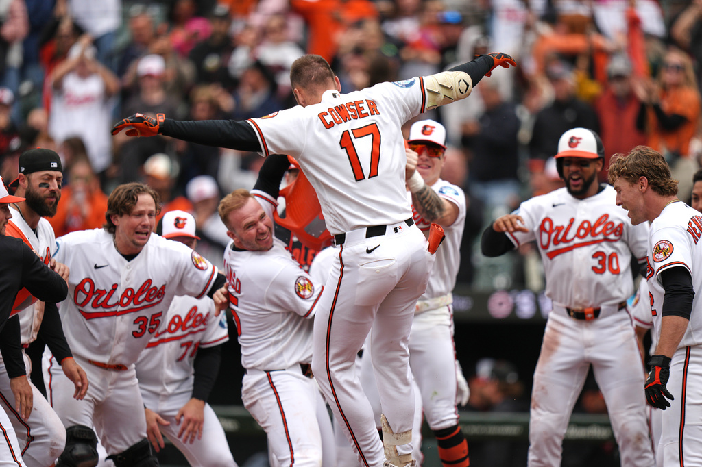 Baltimore Orioles' Colton Cowser (17) celebrates with teammates after hitting a walkoff three-run home run during the ninth inning in the first baseball game of a doubleheader against the Detroit Tigers, Sunday, May 24, 2026, in Baltimore. (AP Photo/Stephanie Scarbrough)