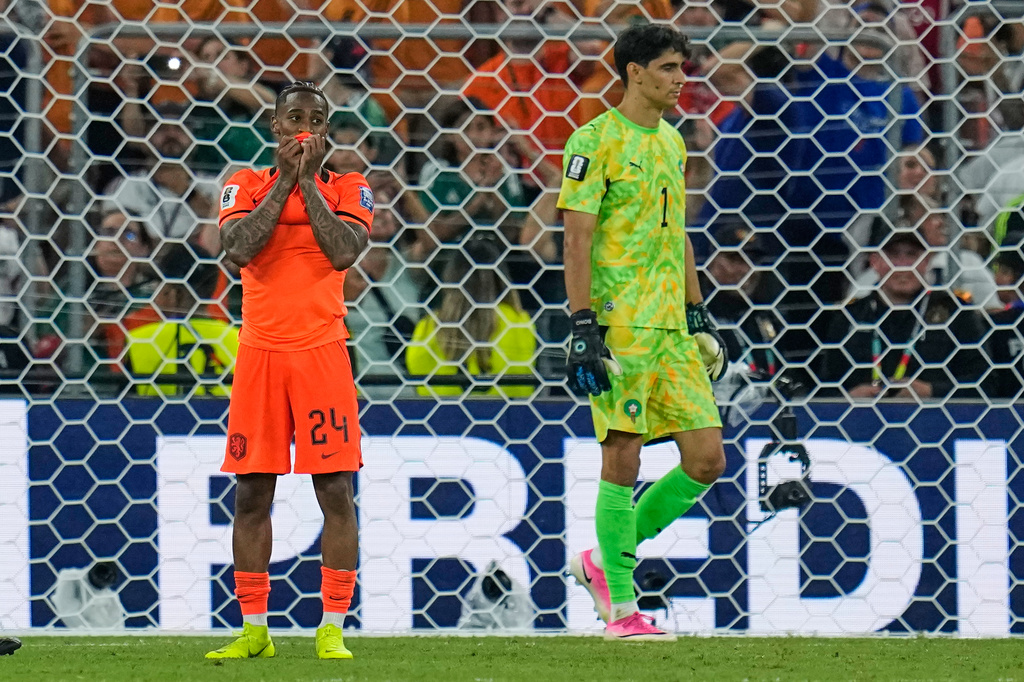Netherlands' Crysencio Summerville (24) reacts after missing a penalty as Morocco goalkeeper Yassine Bounou (1) walks past during the World Cup round of 32 soccer match between the Netherlands and Morocco in Guadalupe, near Monterrey, Mexico, Monday, June 29, 2026. (AP Photo/Ricardo Mazalan)