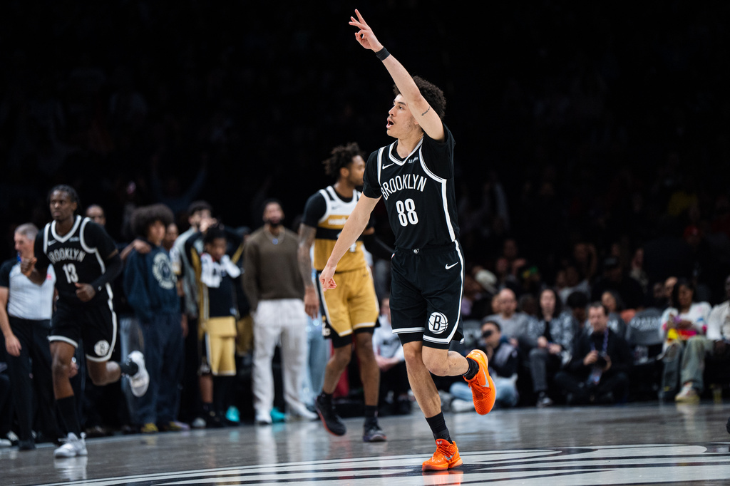 Brooklyn Nets guard Nolan Traore (88) celebrates shooting a three-pointer during the second half of an NBA basketball game against the Washington Wizards, Sunday, April 5, 2026, in New York. (AP Photo/Angelina Katsanis)