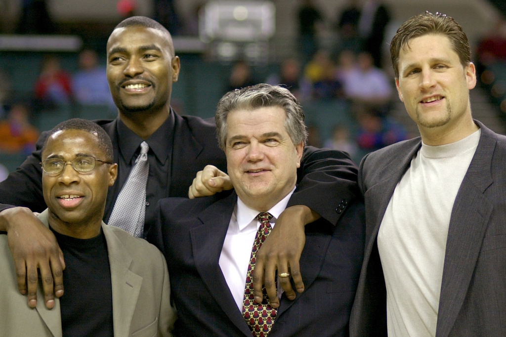 FILE - Members of the 1986 Cleveland State University men's basketball team, from left, Shawn Hood, Eric Mudd, coach Kevin Mackey, and Pat Vuyanich are honored during halftime of an NCAA college basketball game, Jan. 20, 2001, in Cleveland. (Larry Hamel-Lambert/The Plain Dealer via AP, File)