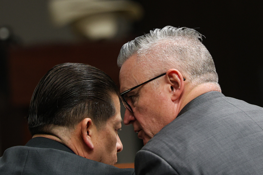 Former Uvalde school district police officer Adrian Gonzales talks with defense attorney Gary Hillier during the seventh day of Gonzales' trial at the Nueces County Courthouse in Corpus Christi, Texas, Wednesday, Jan. 14, 2026. (Sam Owens/The San Antonio Express-News via AP, Pool)