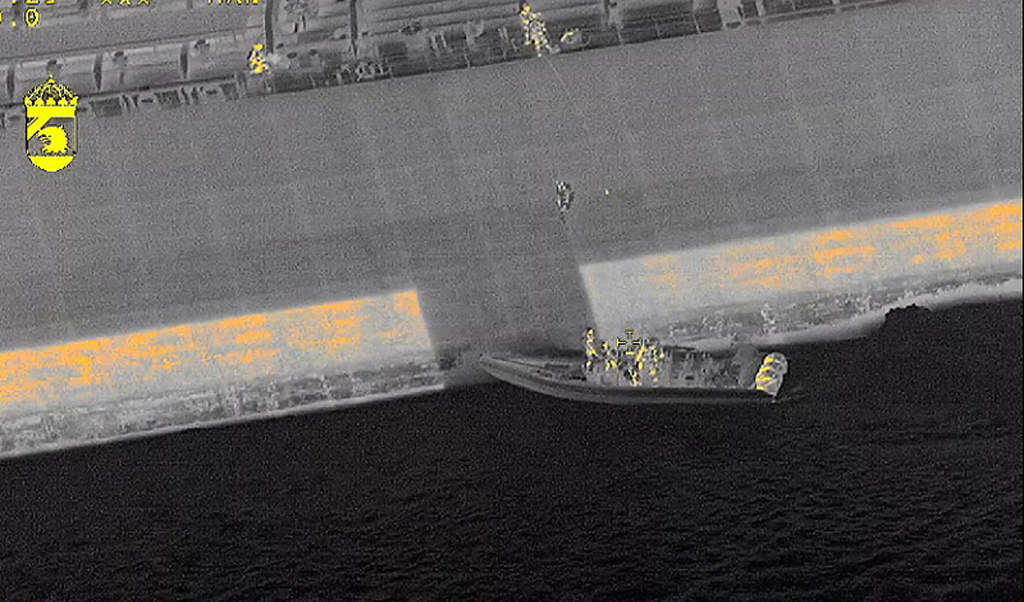 In this image made with a thermal imaging camera and provided by the Swedish Coast Guard, Swedish officials board the tanker "Sea Owl I" on Thursday, March 12, 2026, off the coast of Trelleborg, Sweden, in connection with an investigation into the vessel's seaworthiness. (Swedish Coast Guard via AP)