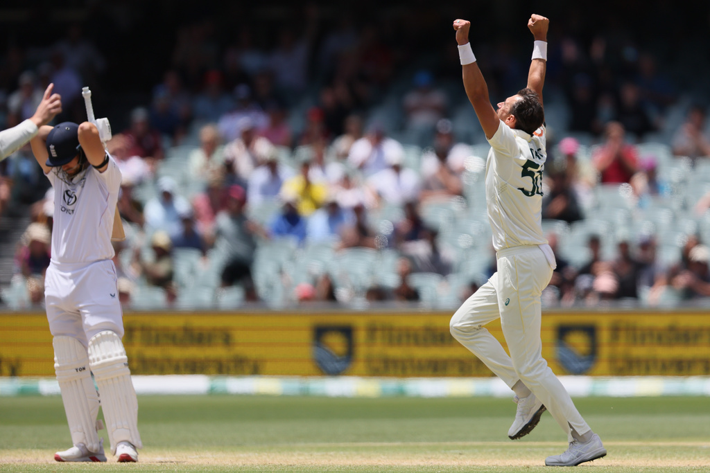 Australia's Mitchell Starc, right, celebrates the wicket of England's Will Jacks, left, during play on the final day of the third Ashes cricket test between England and Australia in Adelaide, Australia, Sunday, Dec. 21, 2025. (AP Photo/James Elsby)