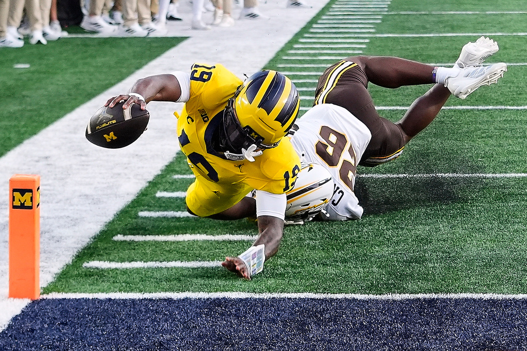 Michigan quarterback Bryce Underwood (19) reaches but is short of the goal line pylon as Western Michigan safety Kouri Crump (26) makes the tackle the during the first half of an NCAA college football game Saturday, Sept. 5, 2026, in Ann Arbor, Mich. (AP Photo/Paul Sancya)