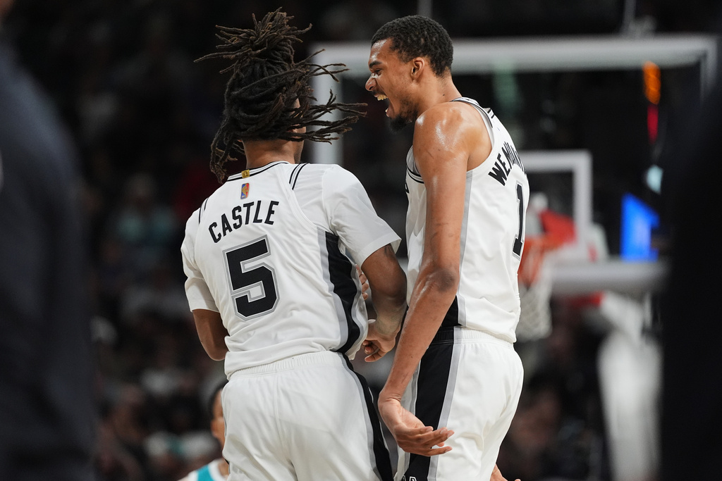 San Antonio Spurs forward Victor Wembanyama (1) celebrates a score with teammate Stephon Castle (5) during the second half of an NBA basketball game against the Charlotte Hornets in San Antonio, Saturday, March 14, 2026. (AP Photo/Eric Gay)