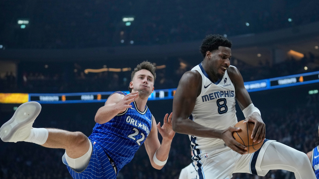 Orlando Magic forward Franz Wagner (22) and Memphis Grizzlies forward Jaren Jackson Jr. (8) challenge for the ball during an NBA basketball game between Orlando Magic and Memphis Grizzlies in Berlin, Germany, Thursday, Jan. 15, 2026. (AP Photo/Ebrahim Noroozi)