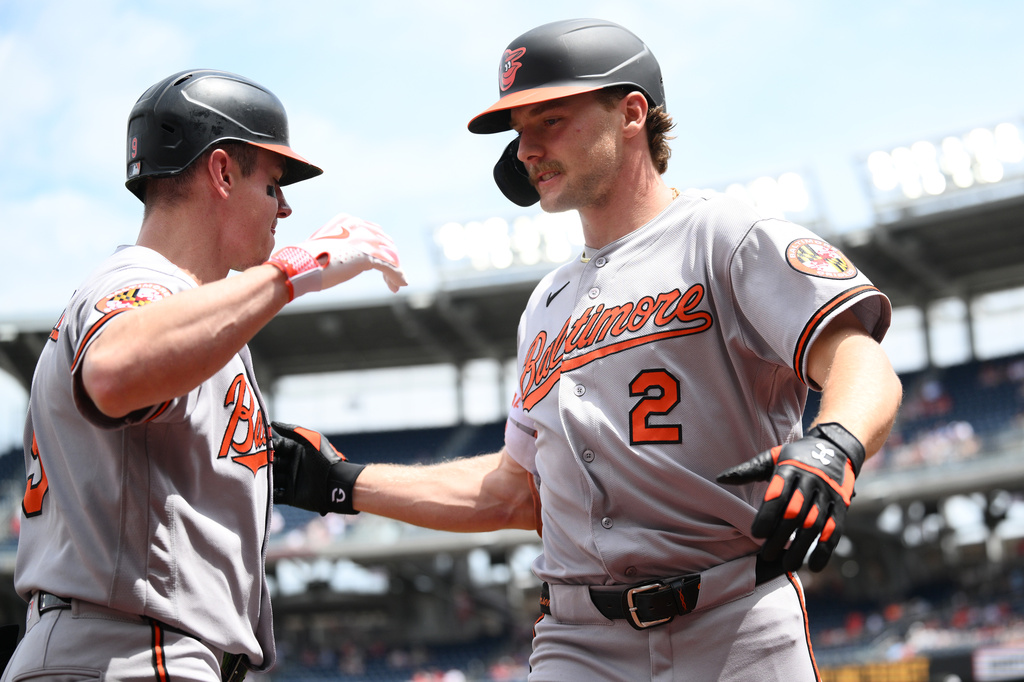 Baltimore Orioles' Gunnar Henderson, right, celebrates after his home run with Tyler O'Neill, left, during the first inning of a baseball game against the Washington Nationals, Sunday, May 17, 2026, in Washington. (AP Photo/Nick Wass)