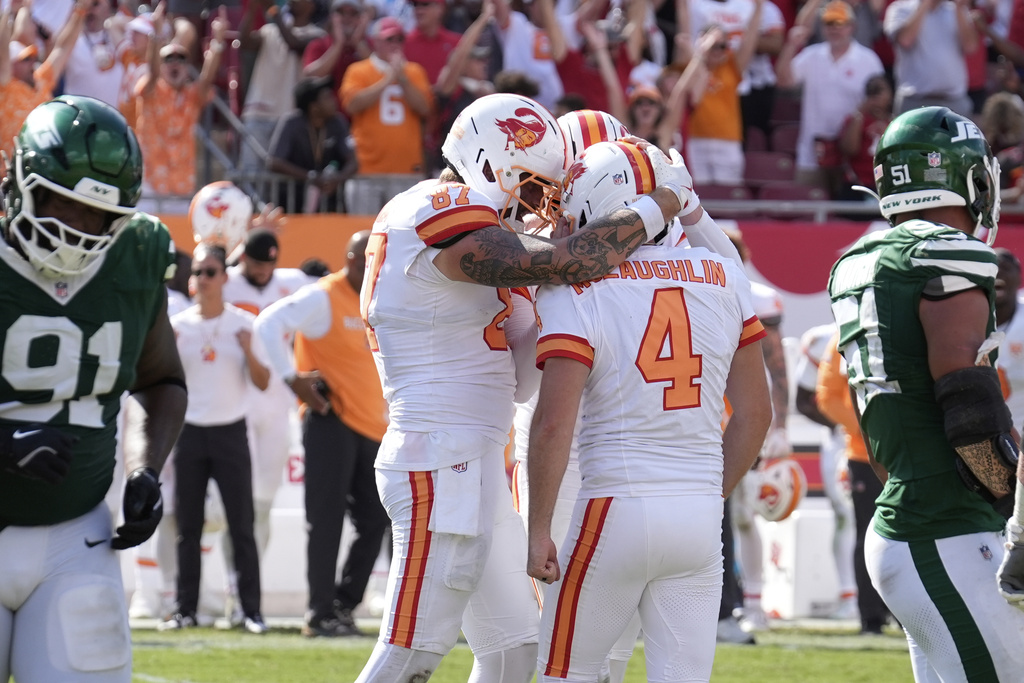 Tampa Bay Buccaneers kicker Chase McLaughlin (4) is hugged by his teammates after scoring a field goal to win the game during the second half of an NFL football game against the New York Jets Sunday, Sept. 21, 2025, in Tampa, Fla. (AP Photo/Chris O'Meara)