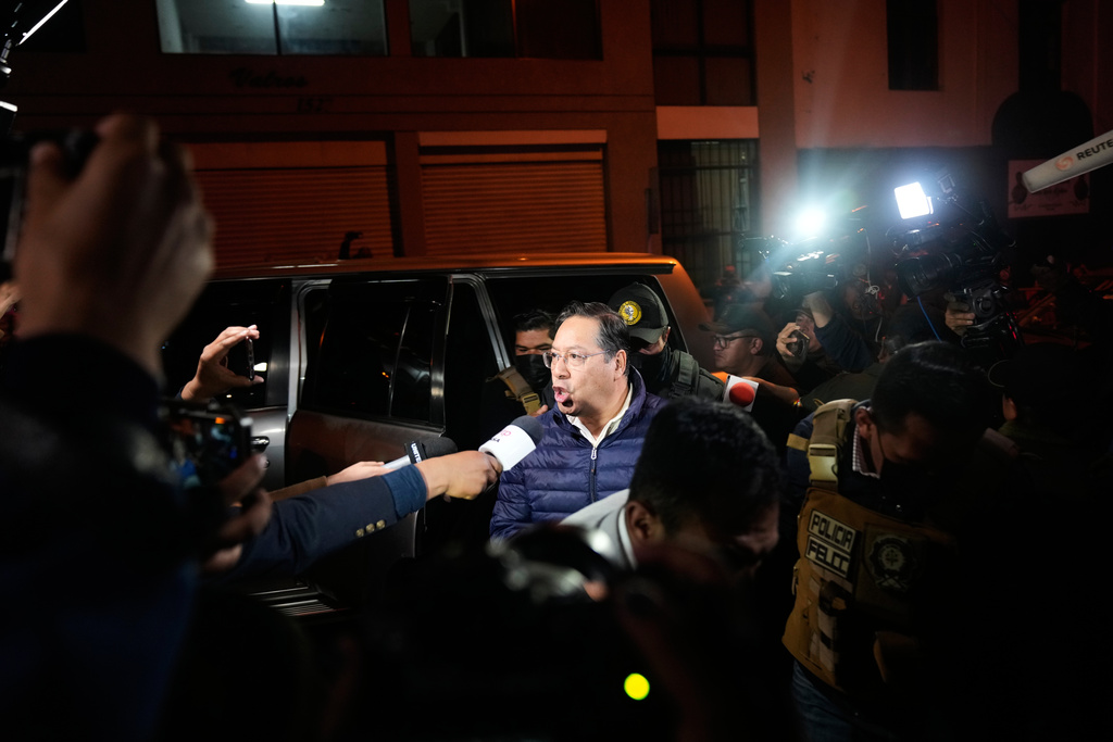 Former President Luis Arce comments to the press as he is escorted to San Pedro Prison after his arrest as part of a corruption investigation in La Paz, Bolivia, Friday, Dec. 12, 2025. (AP Photo/Juan Karita)