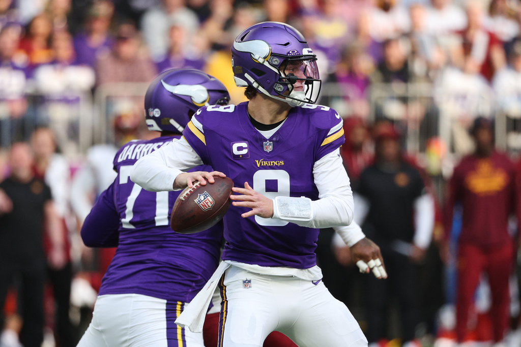 Minnesota Vikings quarterback J.J. McCarthy (9) looks to pass during the first half of an NFL football game against the Washington Commanders, Sunday, Dec. 7, 2025, in Minneapolis. (AP Photo/Matt Krohn)