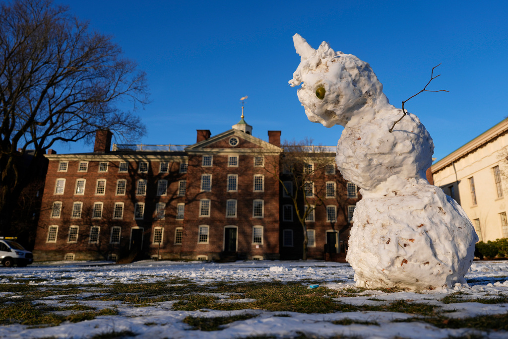 A snowman begins to sag on the usually-bustling Main Green at Brown University, where the fall semester was canceled a week early following the campus shooting, Wednesday, Dec. 17, 2025, in Providence, R.I. (AP Photo/Robert F. Bukaty)