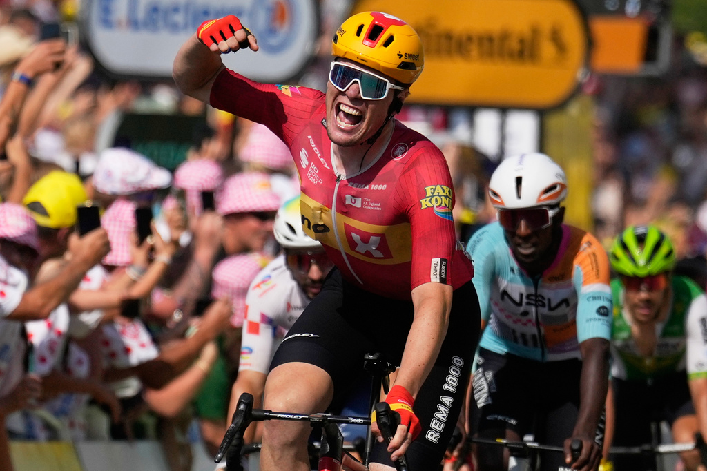 Norway's Soren Waerenskjold celebrates as he crosses the finish line to win the eleventh stage of the Tour de France cycling race with start in Vichy and finish in Nevers, France, Wednesday, July 15, 2026. (AP Photo/Mosa'ab Elshamy)