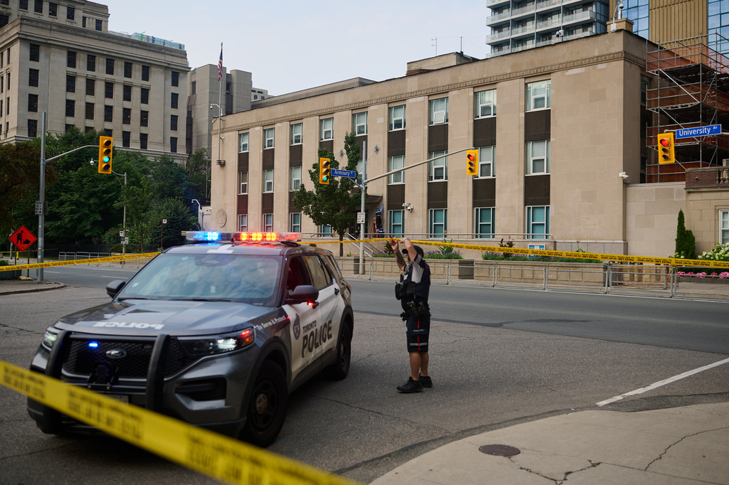 Police work the scene of an early morning shooting outside the US Consulate in Toronto, on Monday, July 27, 2026. (Sammy Kogan/The Canadian Press via AP)