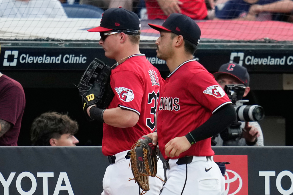 Cleveland Guardians left fielder Cooper Ingle, left, runs in from the outfield with center fielder Steven Kwan, right, after the first half of the seventh inning of a baseball game against the Texas Rangers in Cleveland, Tuesday, June 30, 2026. (AP Photo/Sue Ogrocki)