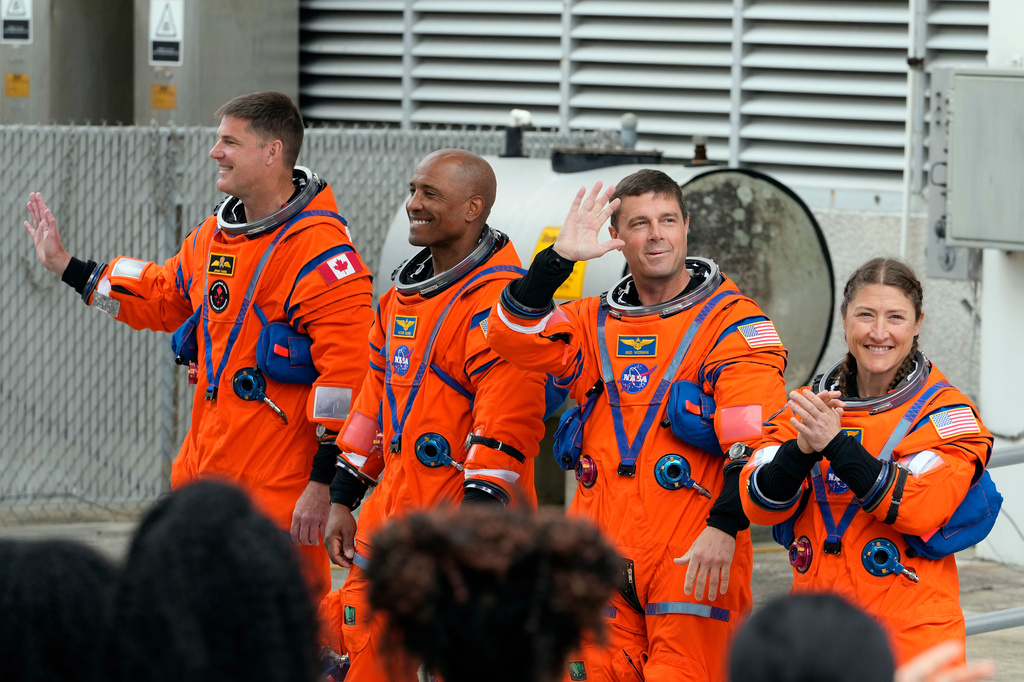 Astronauts , from left, Mission Specialist Jeremy Hansen, of Canada, Pilot Victor Glover, Commander Reid Wiseman and Mission Specialist Christina Koch leave the Operations and Checkout Building for a trip to Launch Pad 39-B and a planned liftoff on NASA's Artemis II moon rocket at the Kennedy Space Center Wednesday, April 1, 2026, in Cape Canaveral, Fla. (AP Photo/Chris O'Meara)