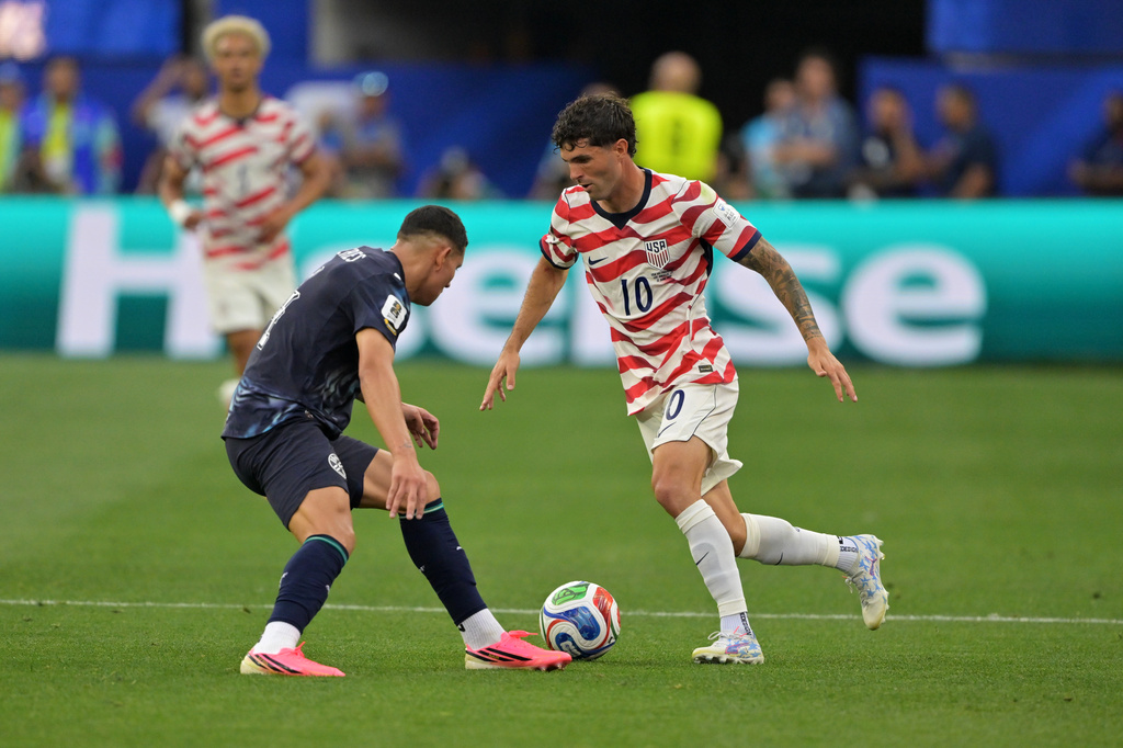 United States' Christian Pulisic (10) dribbles past Paraguay's Juan Jose Caceres during the World Cup Group D soccer match in Inglewood, Calif., near Los Angeles, Friday, June 12, 2026. (AP Photo/Jayne Kamin-Oncea)